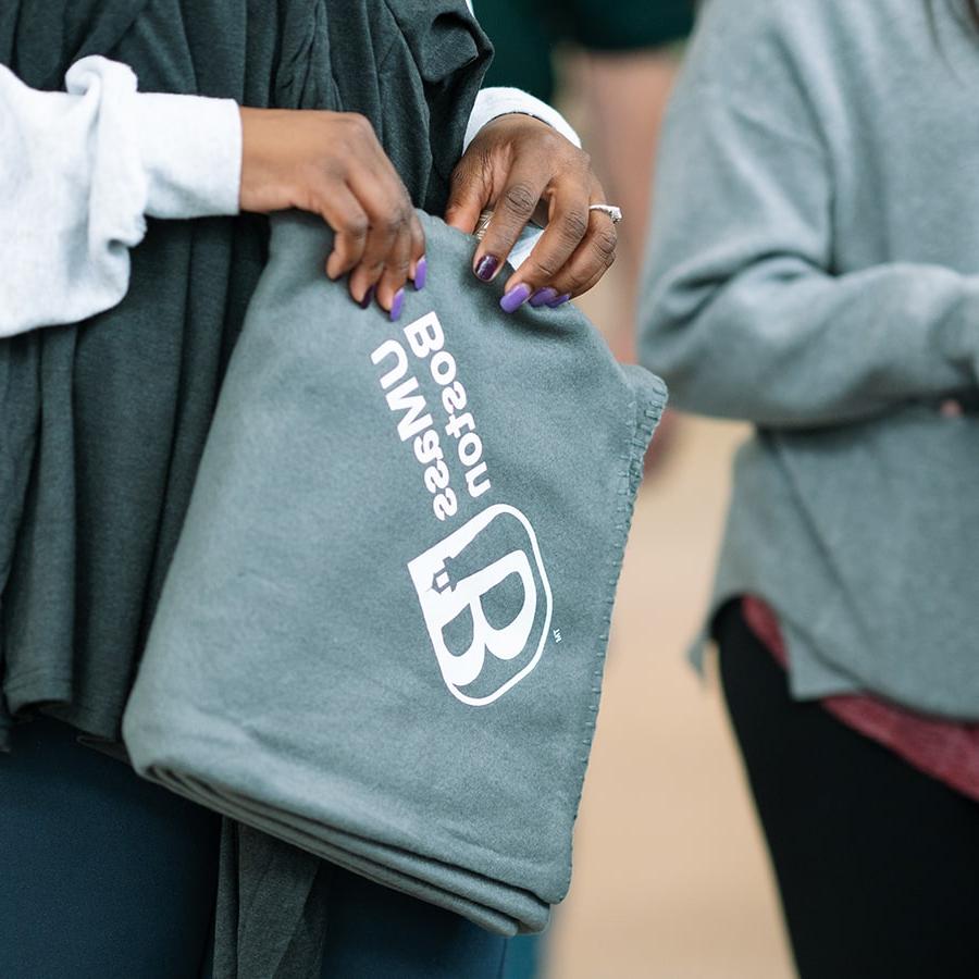 Student holds swag umb blanket close up of hands.